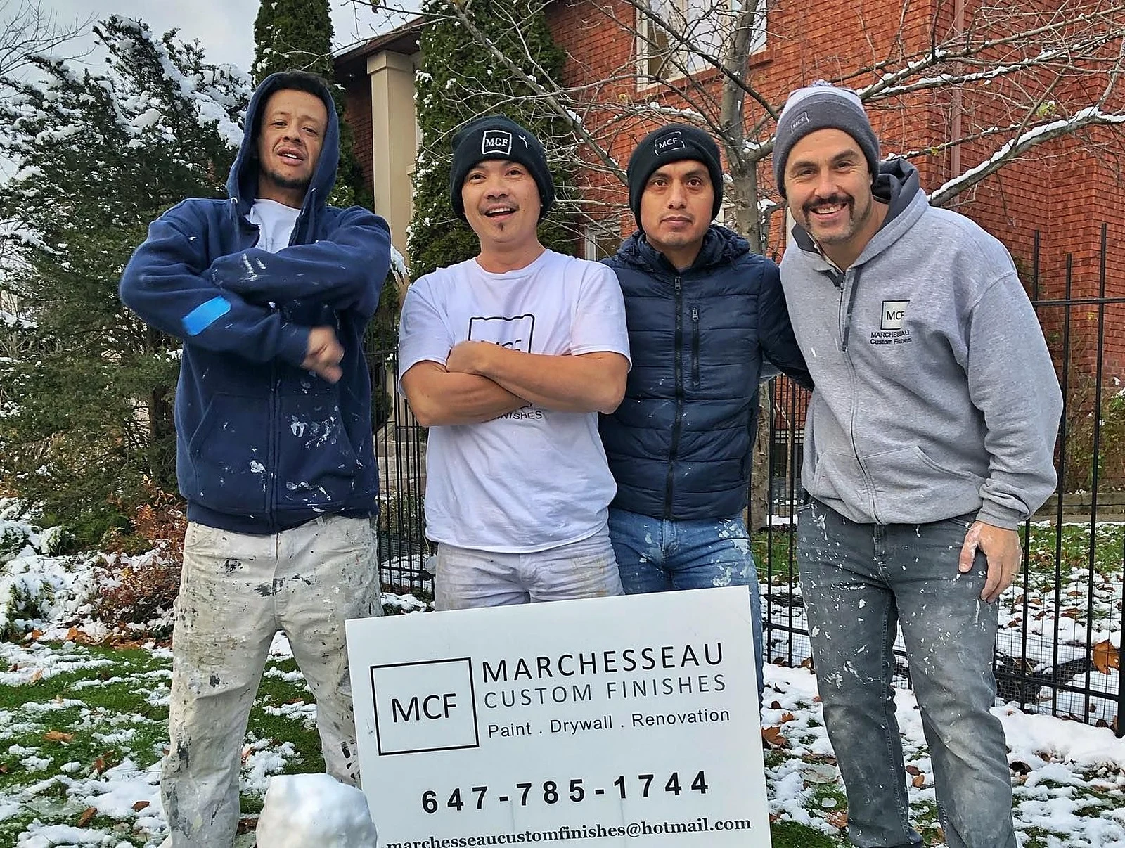 Marchesseau crew on site in winter beside a lawn sign