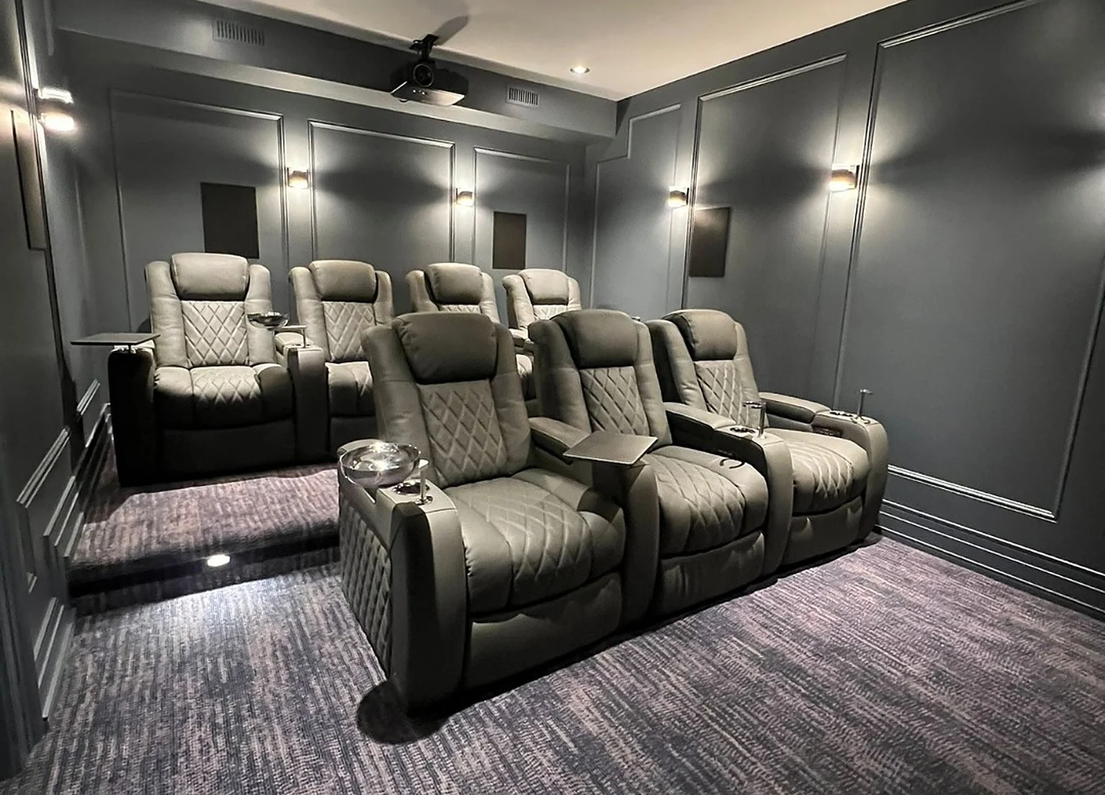 AFTER: home cinema, charcoal panelled walls, recliner seating