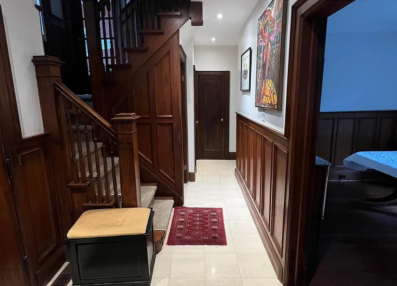 BEFORE: Midtown 1934 house hallway, dark original wood staircase and wainscoting