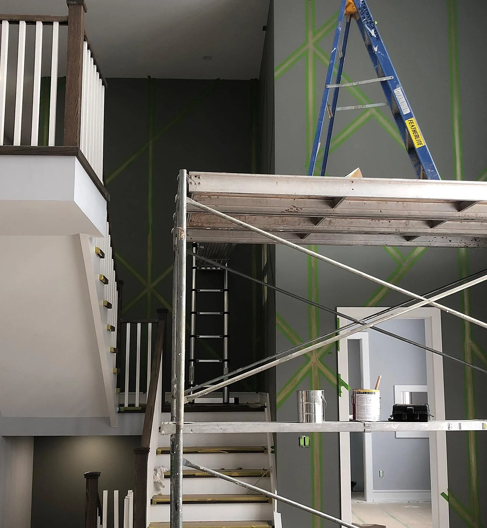 In progress: stairwell with scaffold, green tape geometric layout