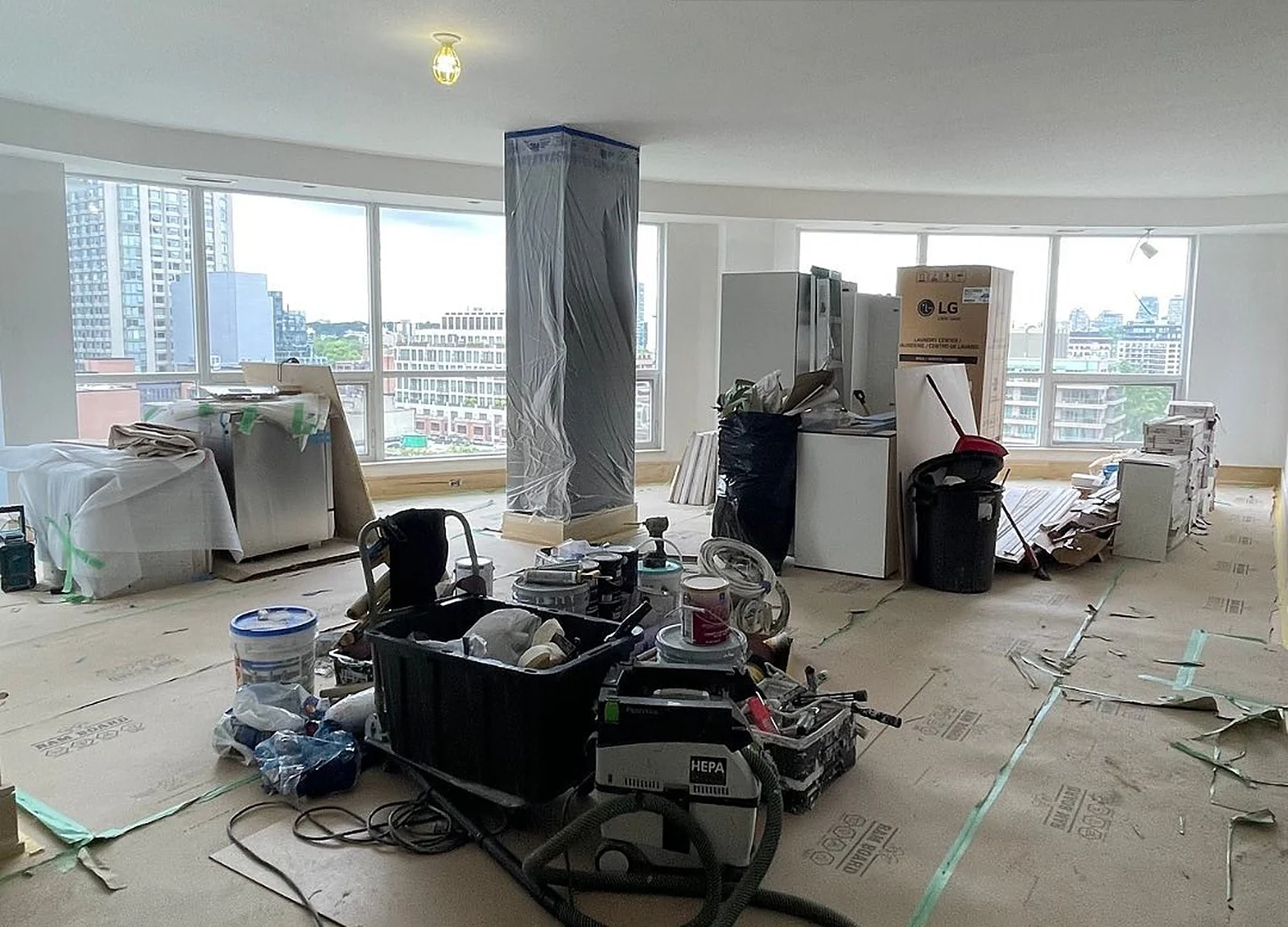 BEFORE: same condo mid-reno with tools and plastic