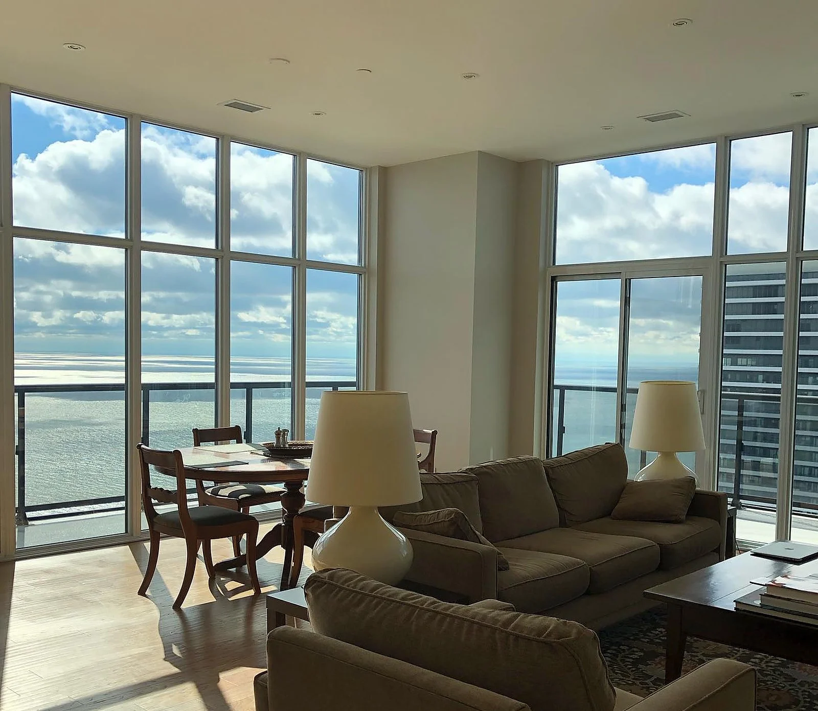 Penthouse living room with lake view, beige walls