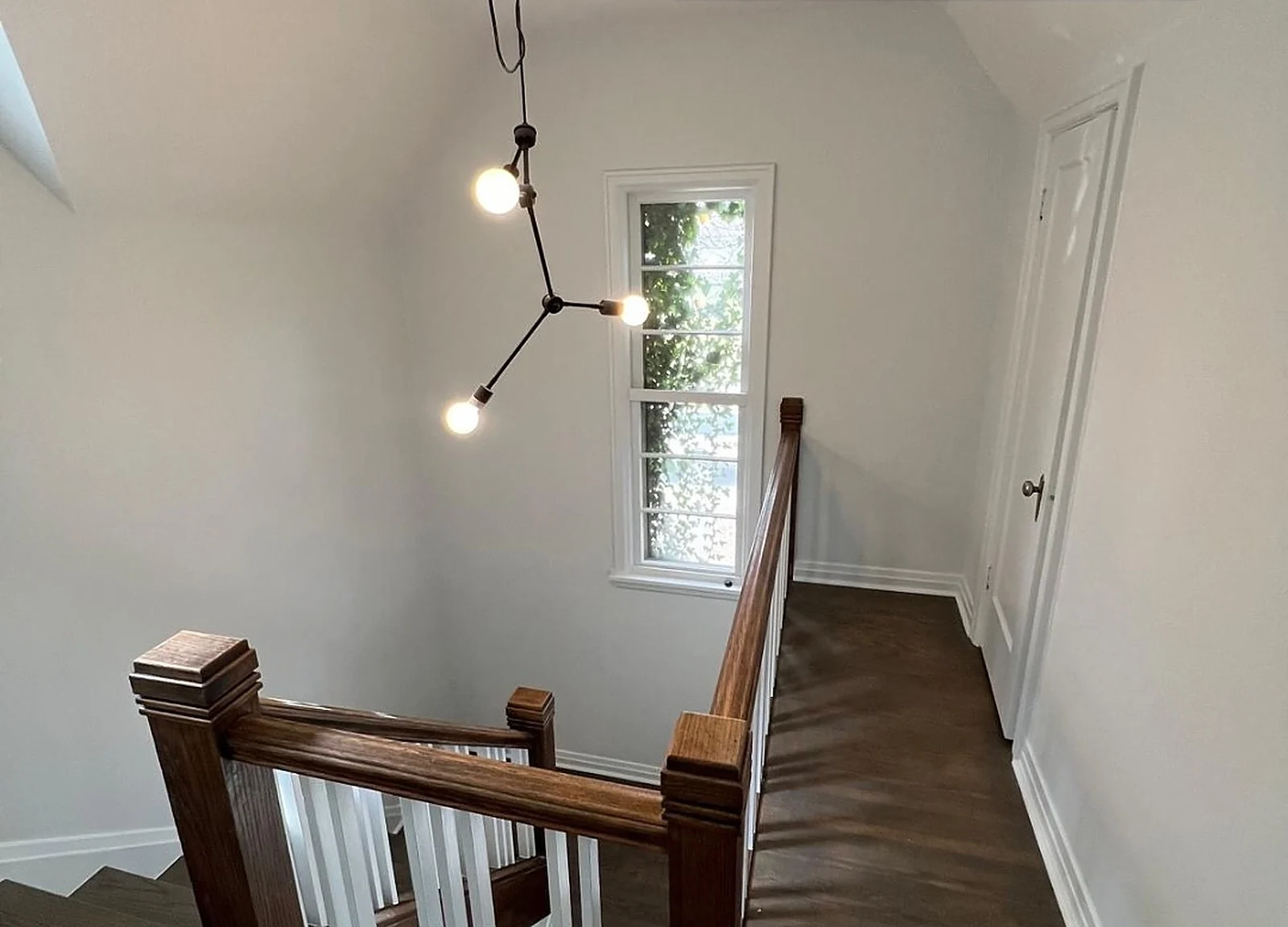 AFTER: hall painted white, dark railing
