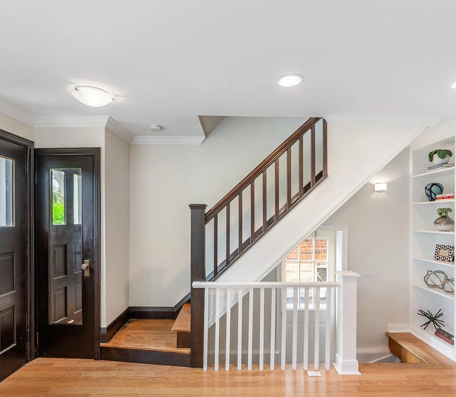 East York entry and staircase, white walls, dark railing