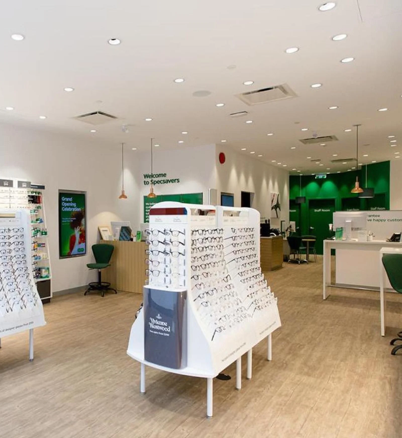 Specsavers store interior, white walls, green accents