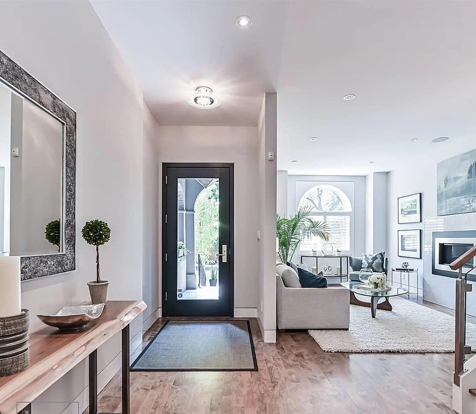 Interior hallway white walls looking to front door (Lome Irwin listing photo)