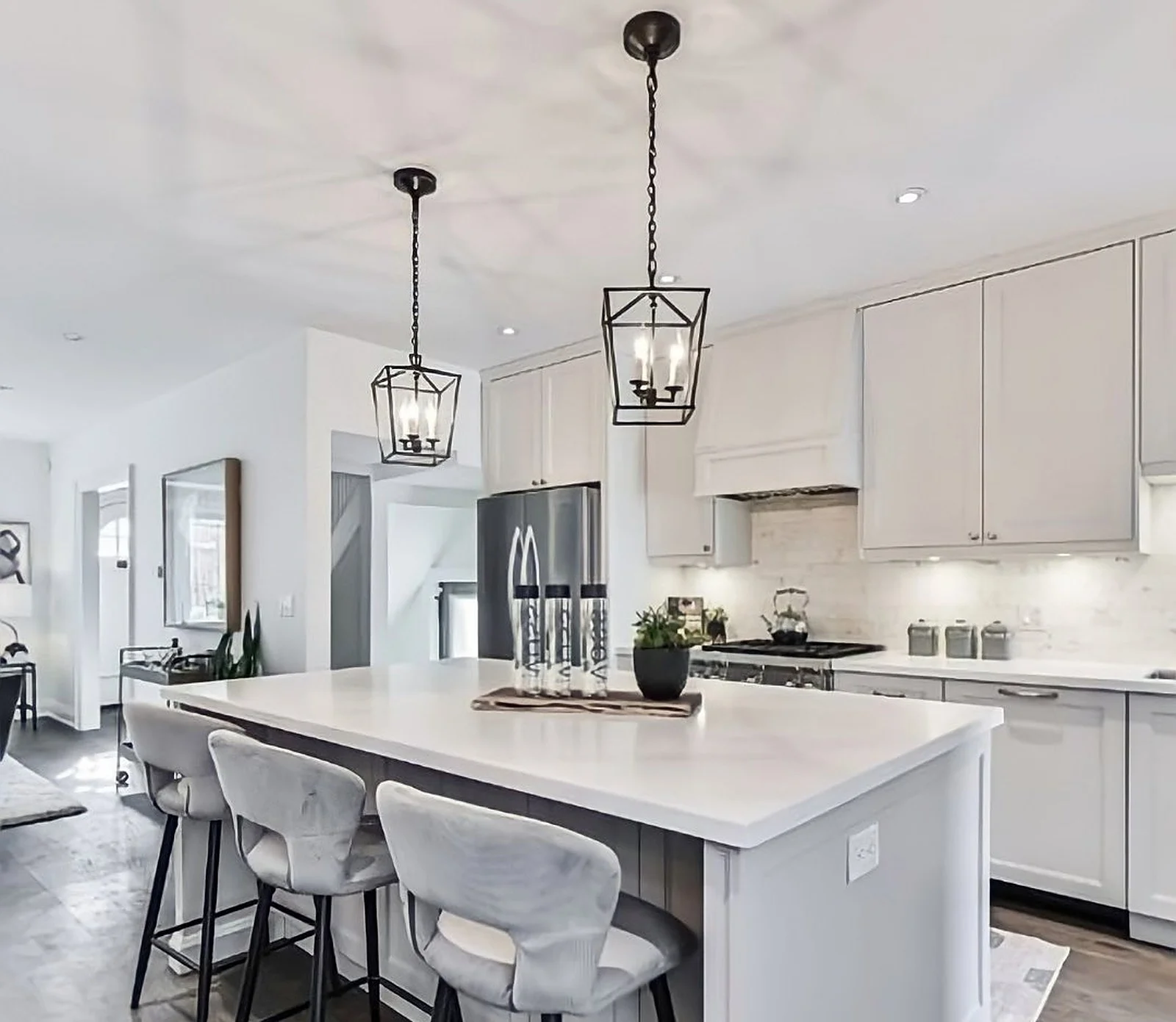 White kitchen with island in a Midtown home after painting