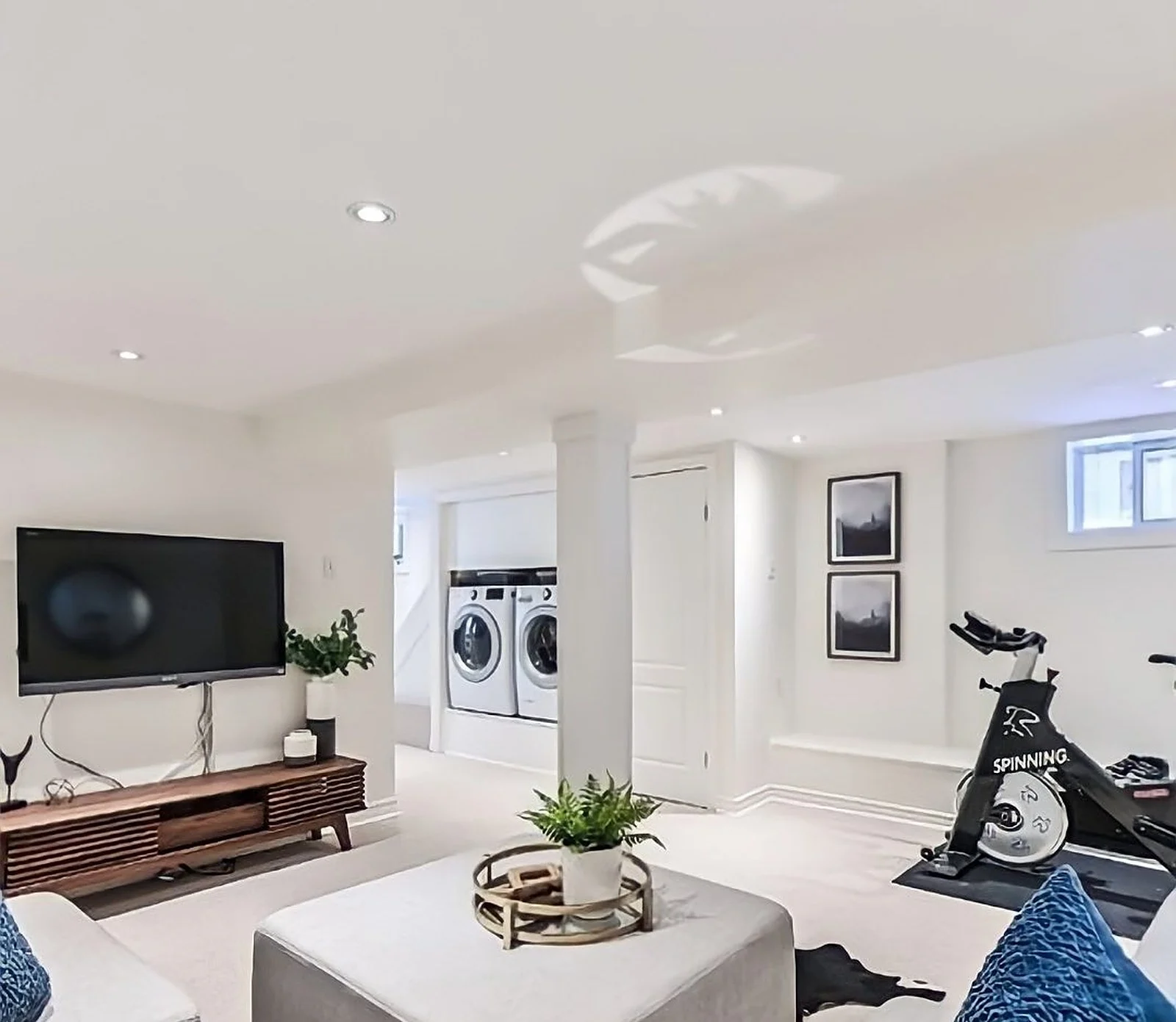 Basement rec room, white walls, laundry