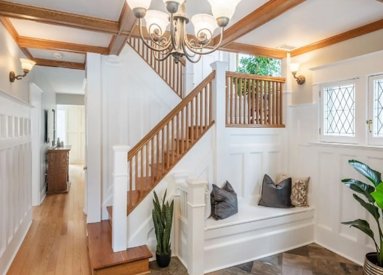 AFTER: foyer white wainscoting, oak treads kept, bench