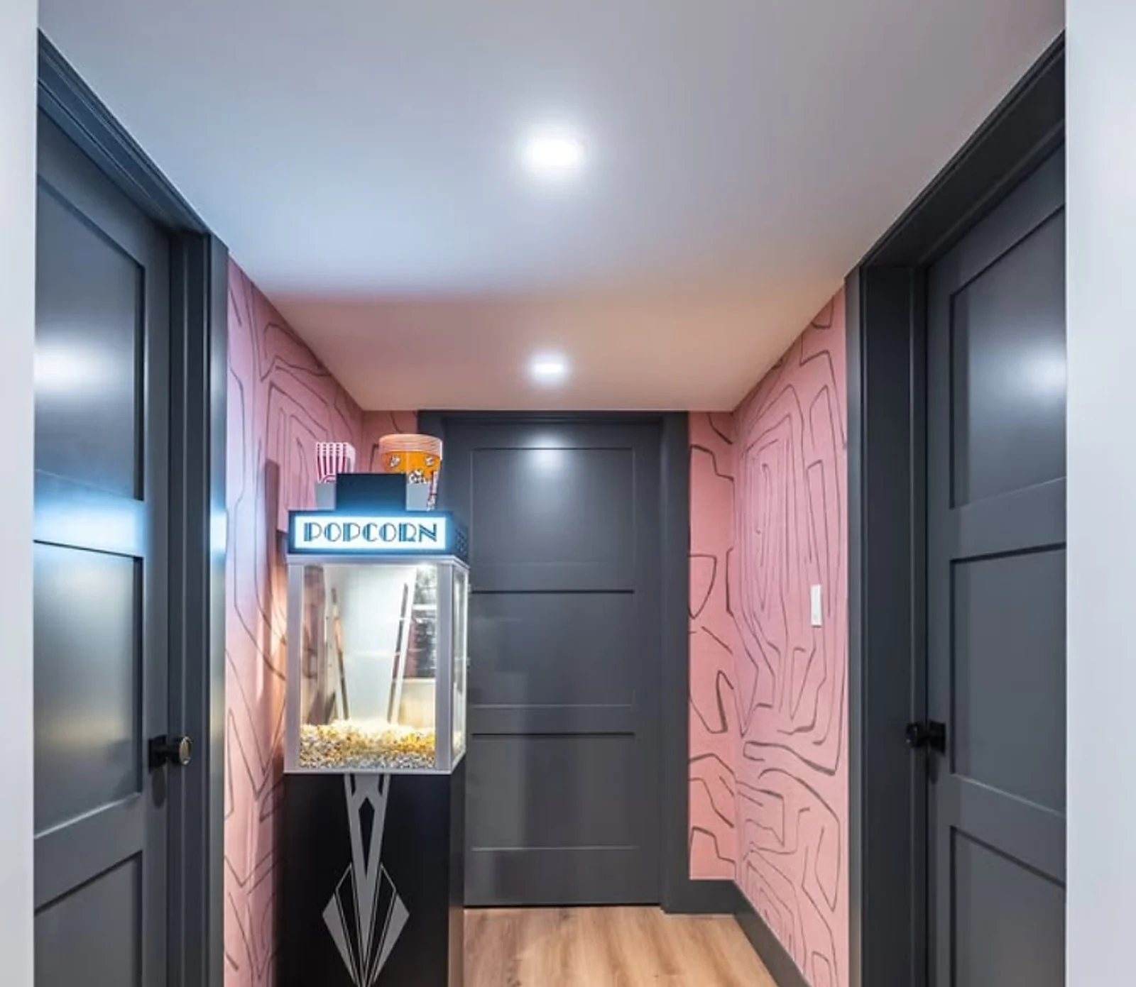 Navy doors and pink patterned feature wall, popcorn machine