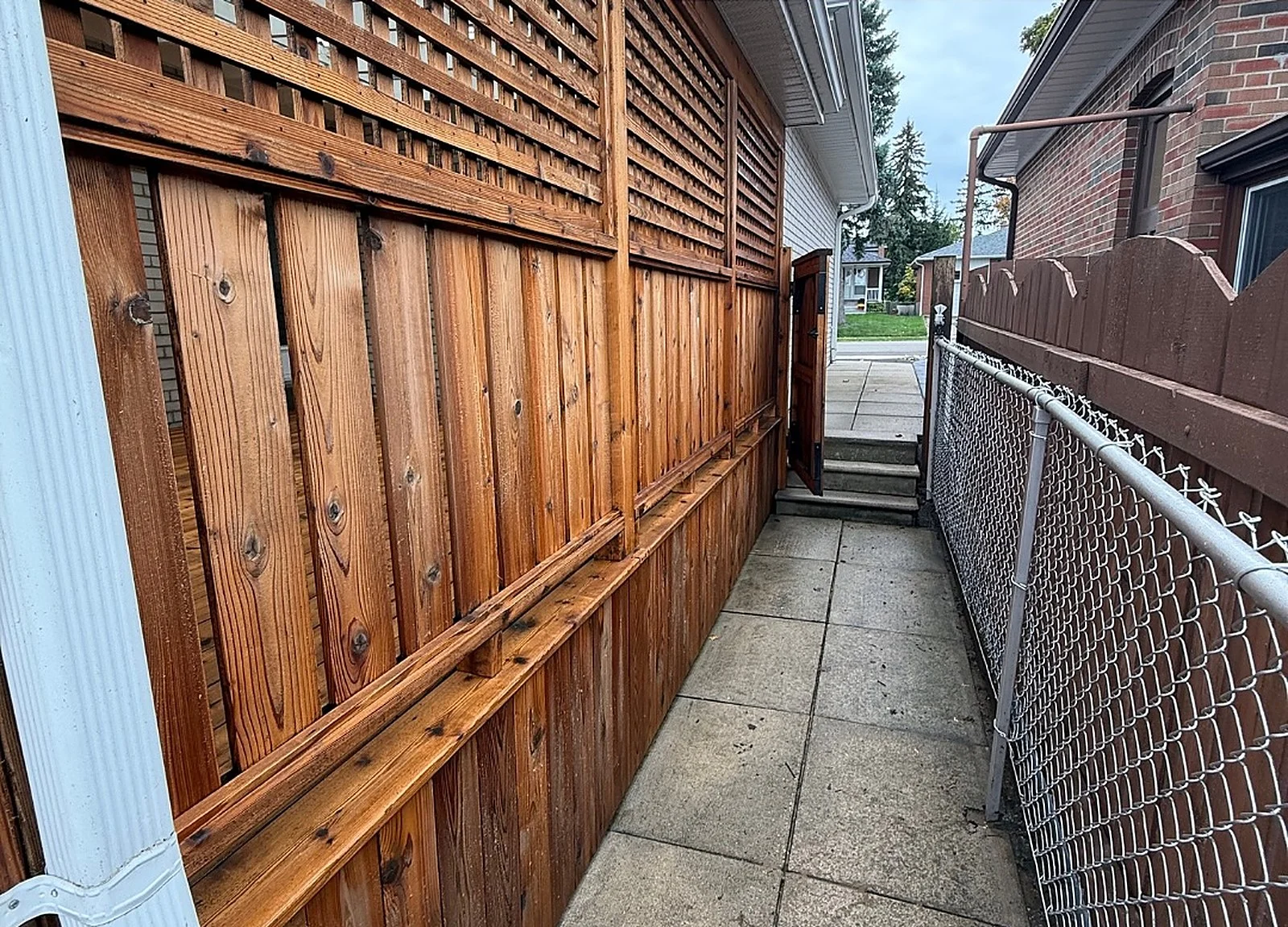 AFTER: cedar privacy fence/lattice along side yard, restored