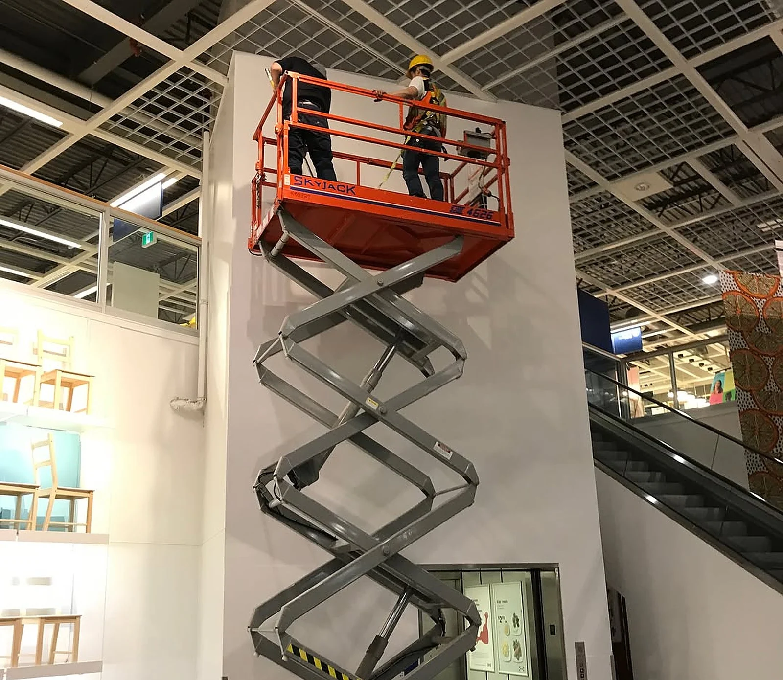 Painters on tall scissor lift at IKEA Vaughan white wall