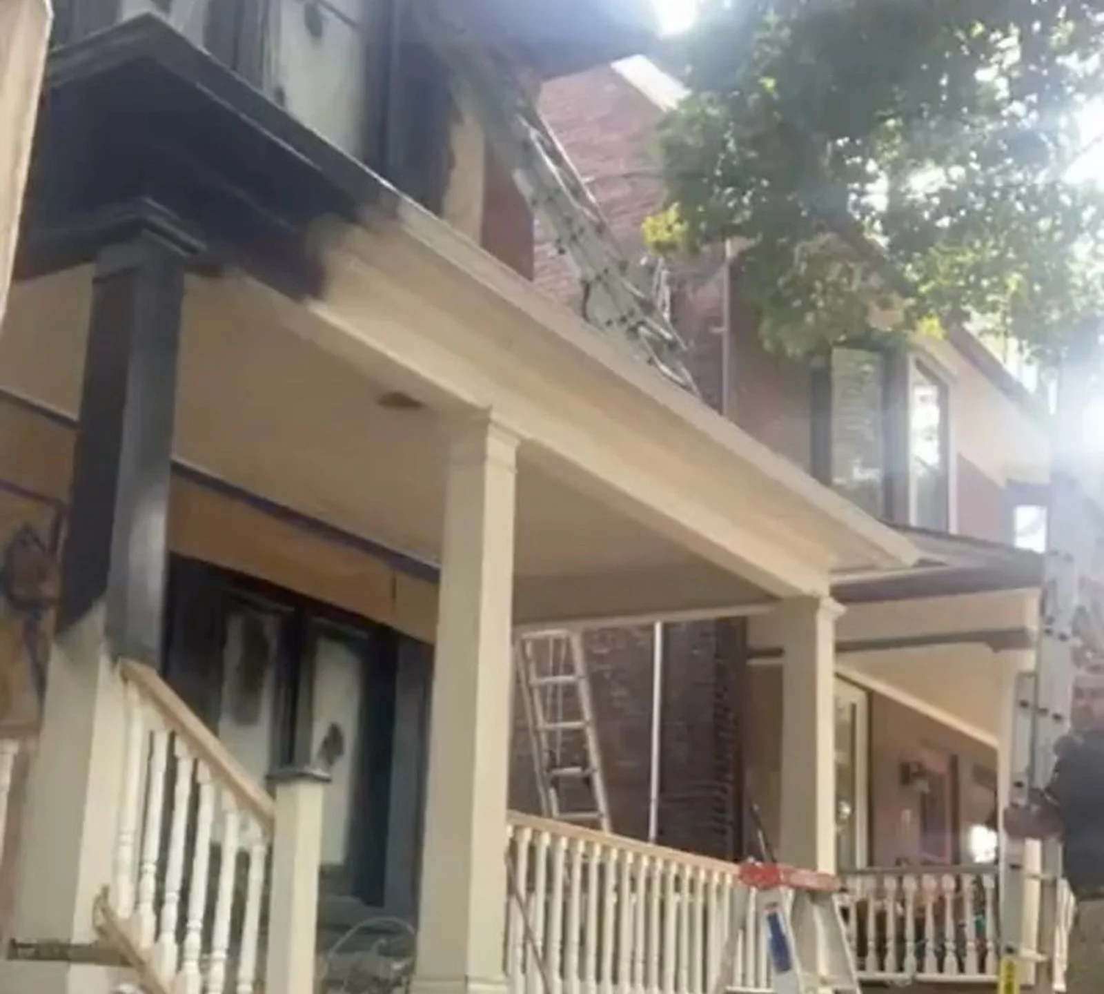 DURING: Riverdale porch masked, ladders, being painted