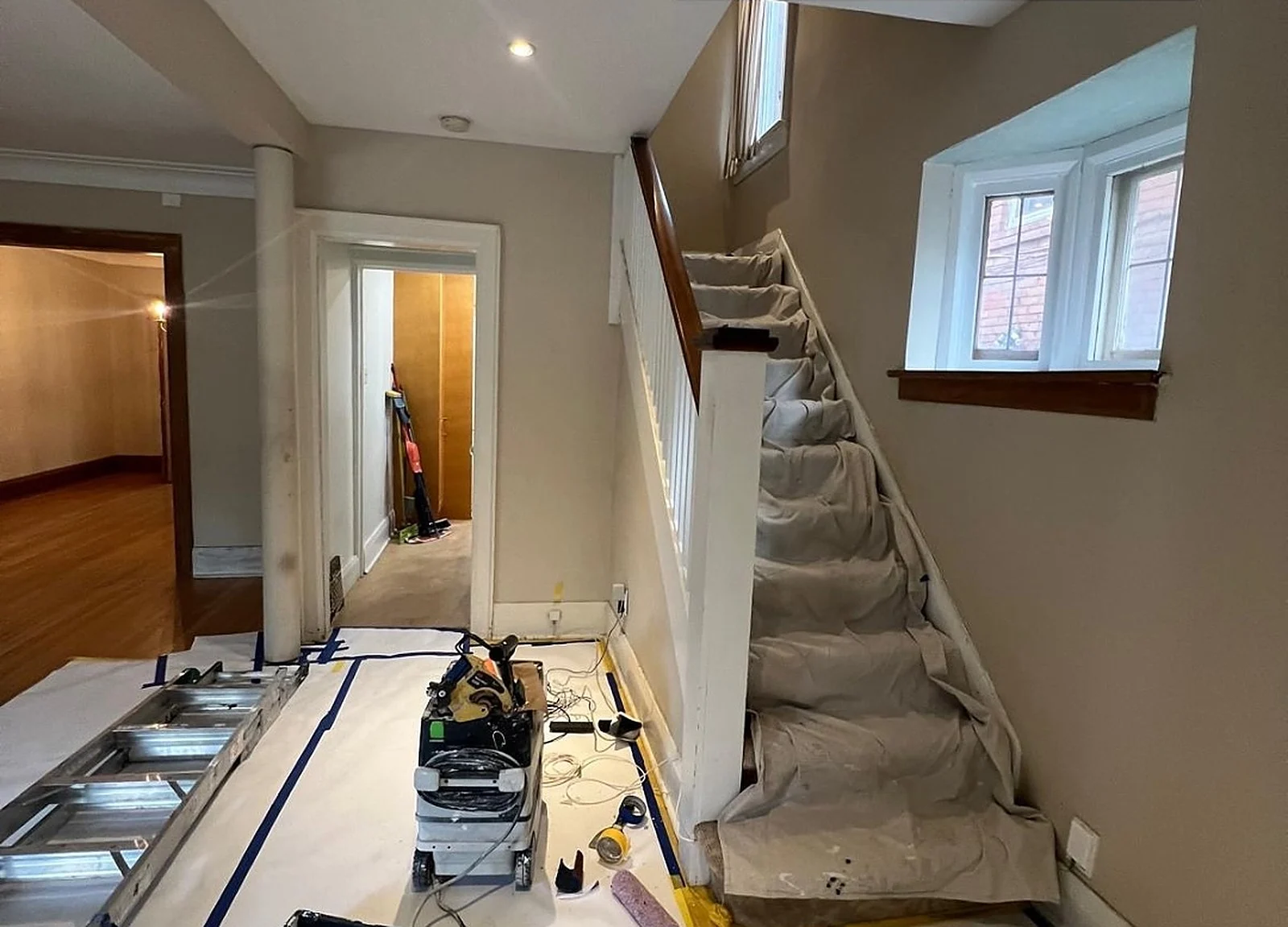 BEFORE: hallway and stairs with masking