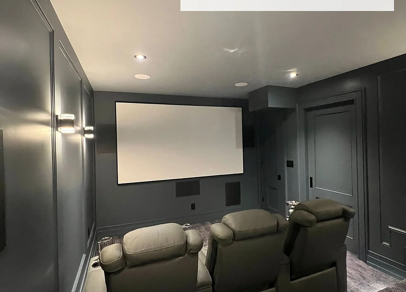 AFTER: dark home theater with screen and recliners