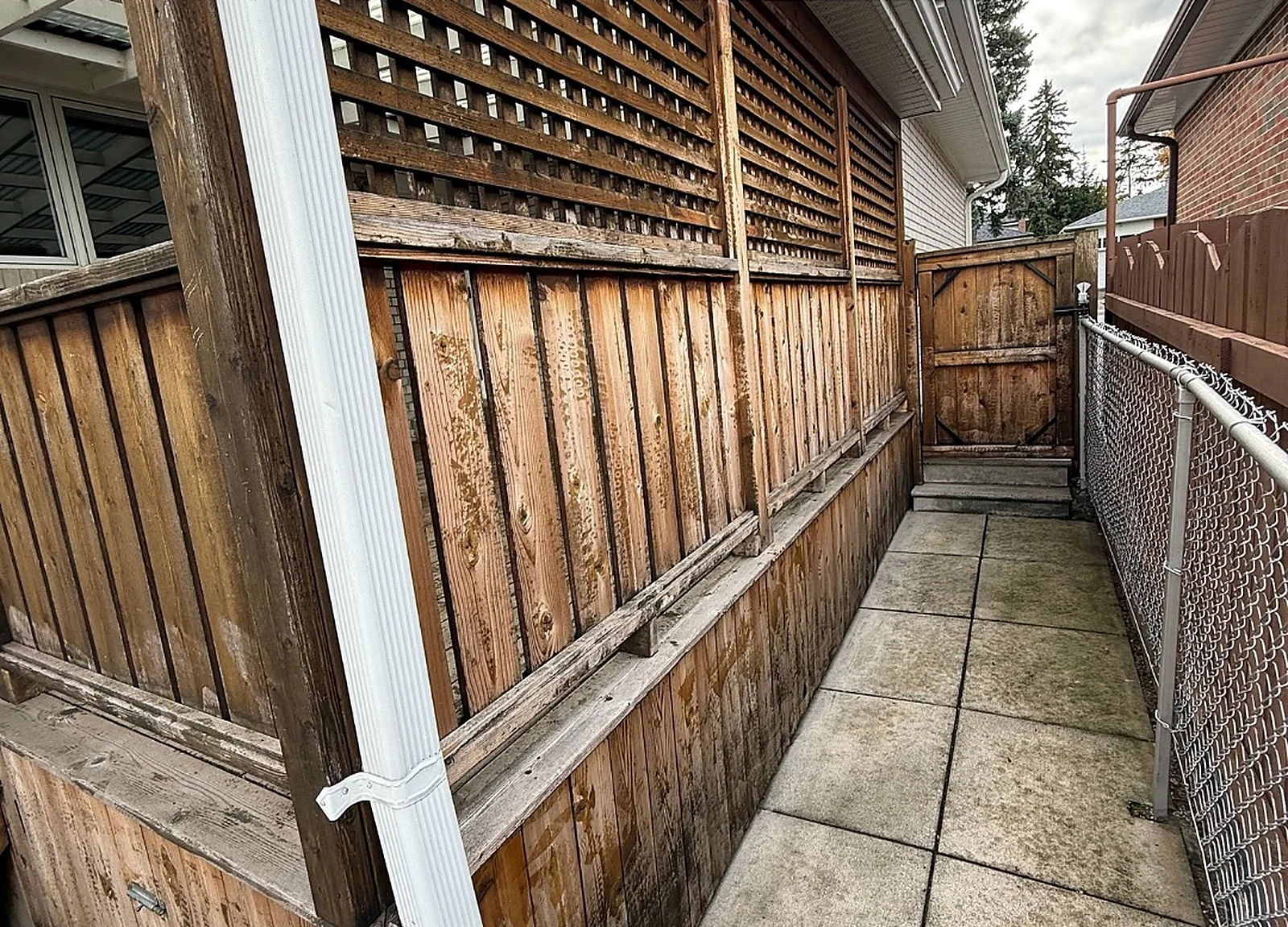 BEFORE: same fence weathered grey