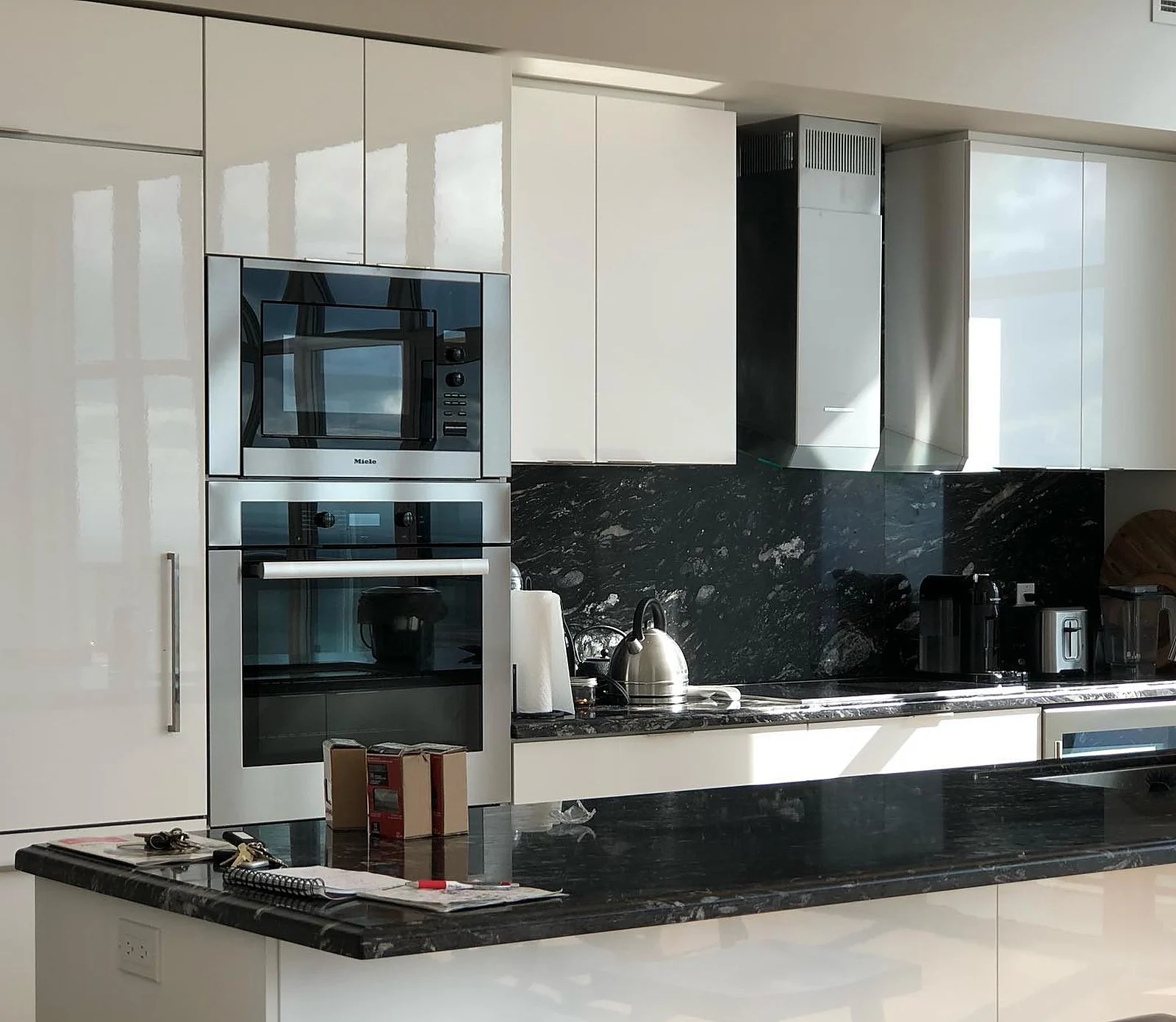 Penthouse modern kitchen, black stone backsplash