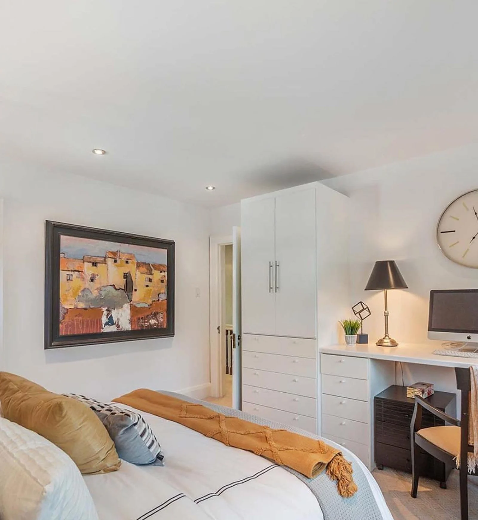 Bedroom with desk, white walls