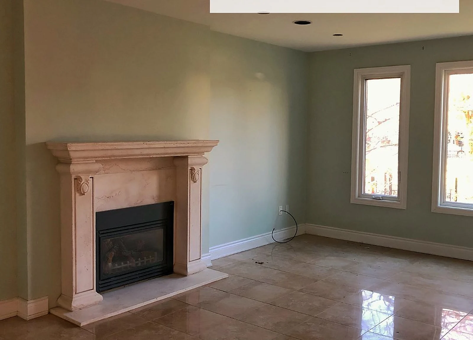 BEFORE: Burlington living room, peach marble fireplace, green-grey walls