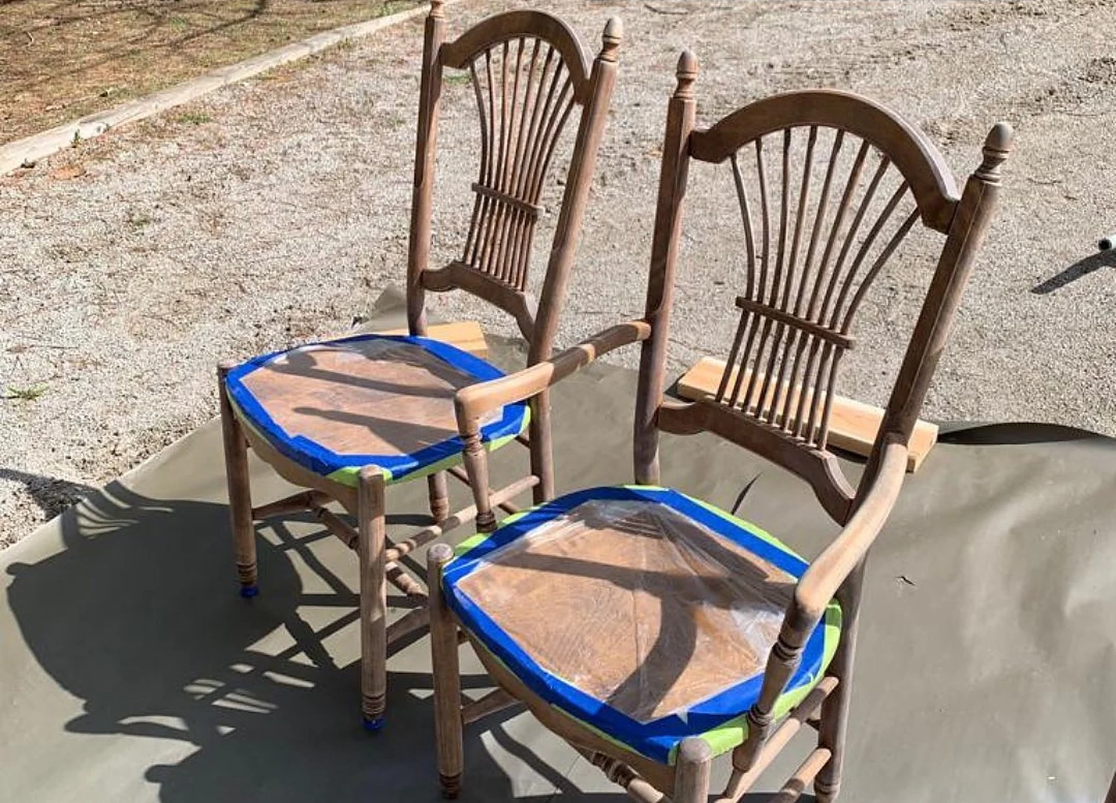 BEFORE: two wooden spindle-back chairs being taped