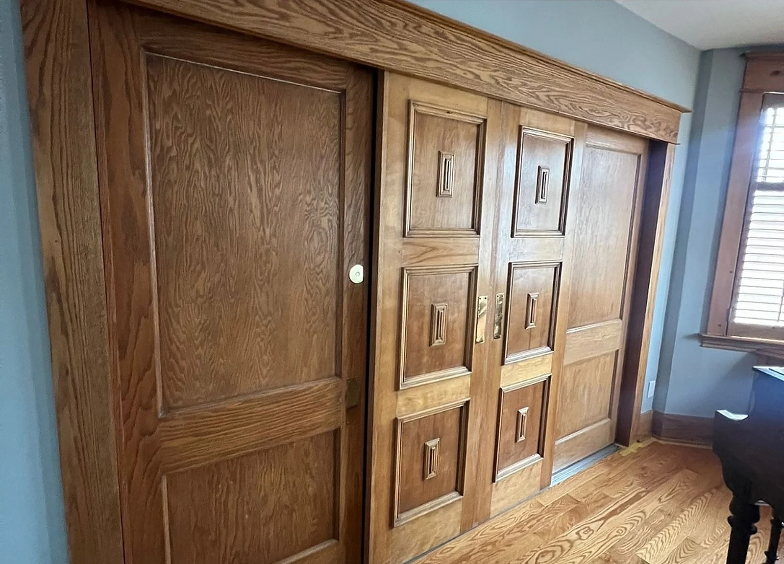 BEFORE: oak sliding pocket doors, blue wall