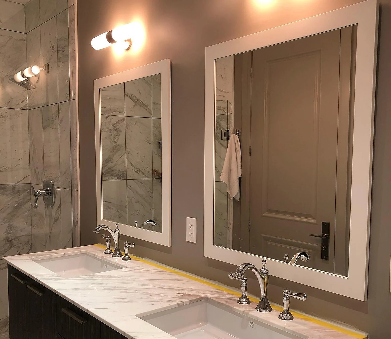 Penthouse bathroom, taupe walls, double mirrors