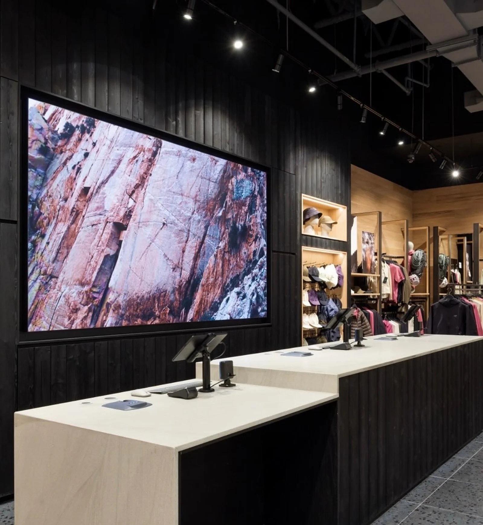Arc'teryx black ribbed wall with large screen, display counter