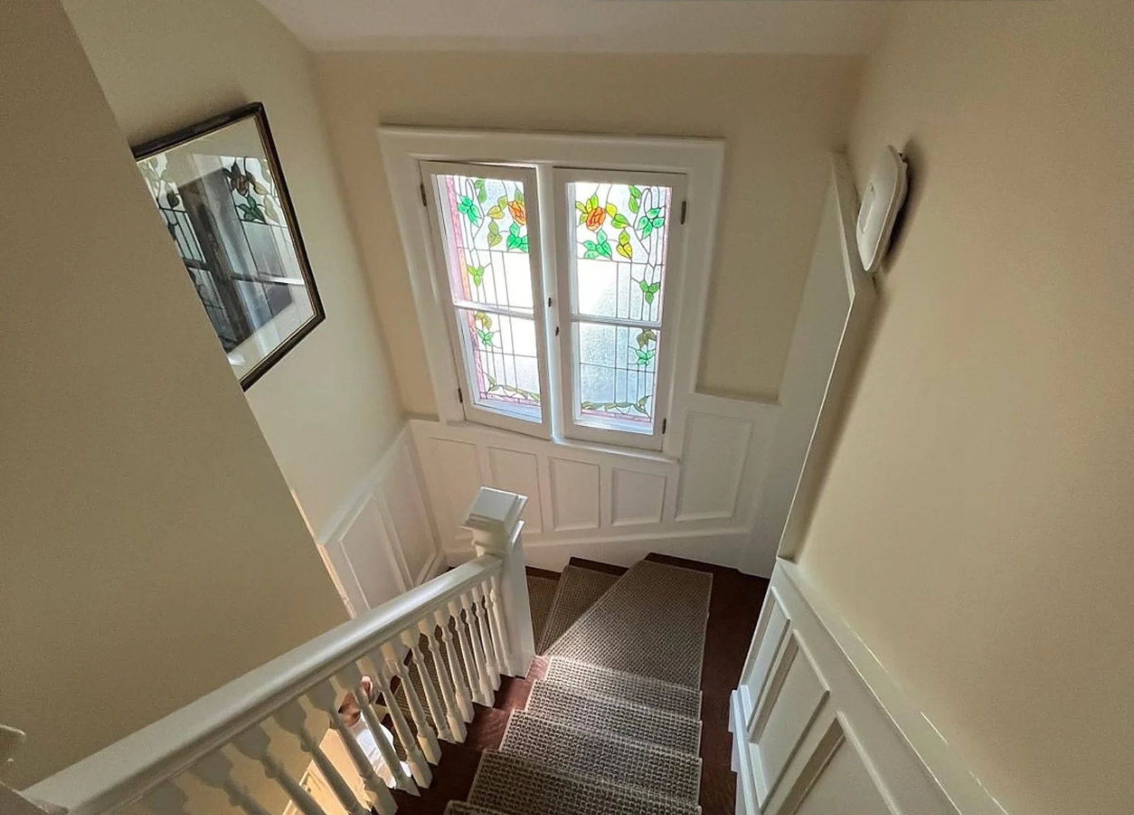 AFTER: landing with white railings, stained glass