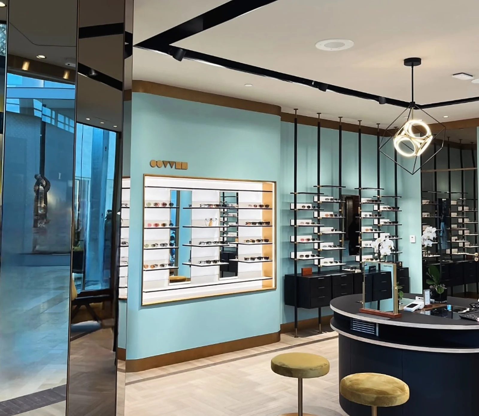 Oliver Peoples interior, pale aqua walls, counter