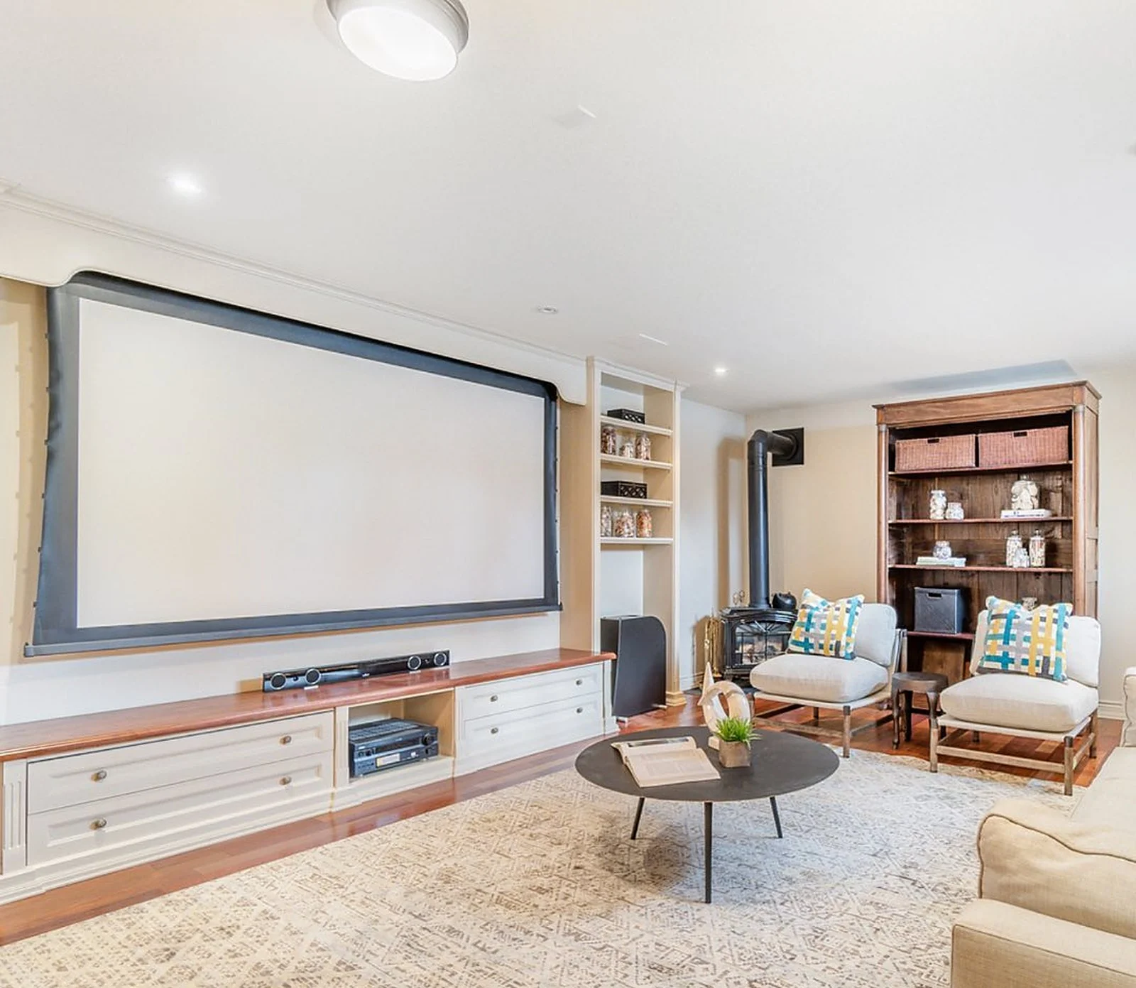 Lawrence Park media room with projector screen, white built-ins