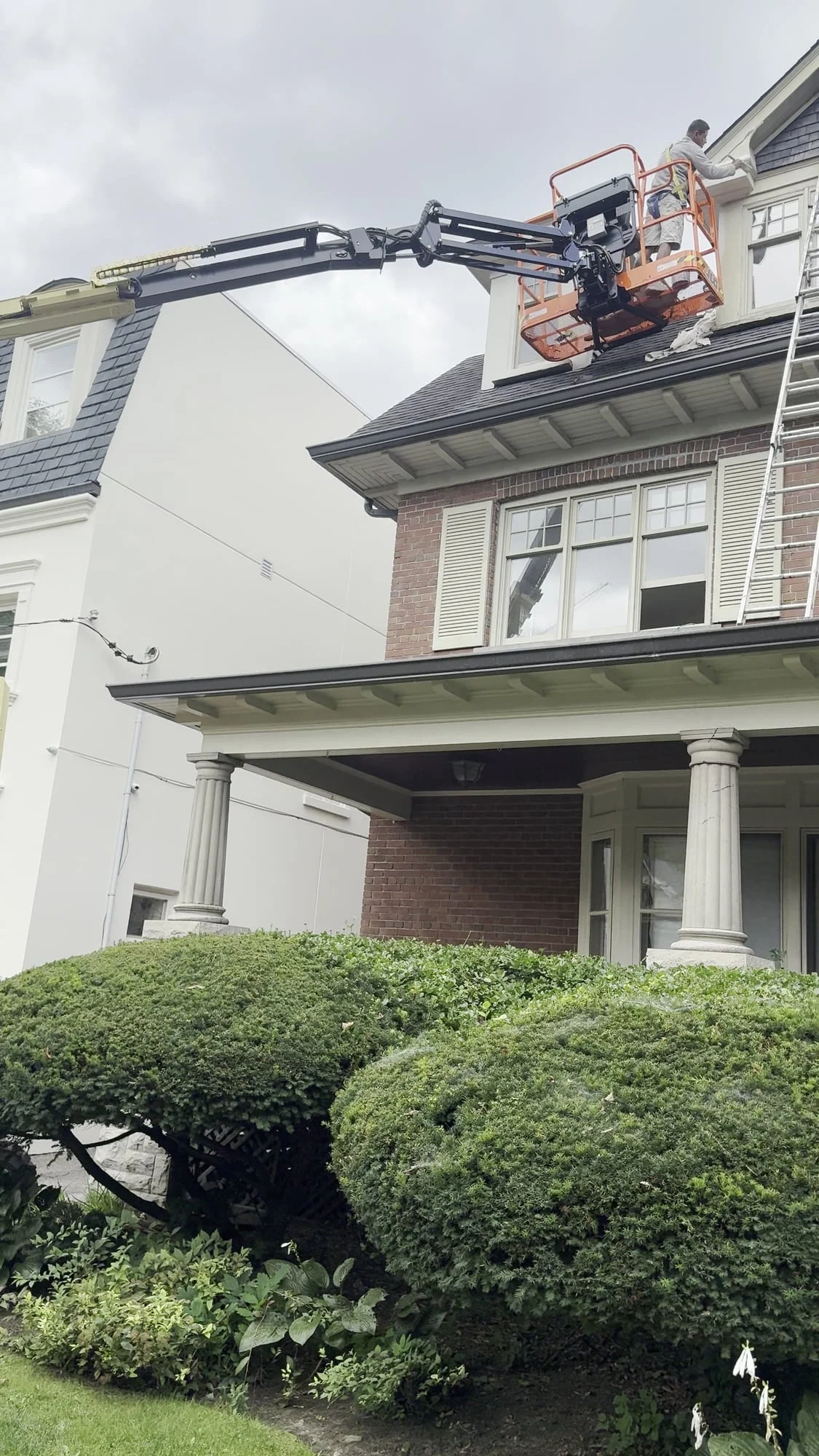 Boom lift at the third-floor dormer during the exterior repaint