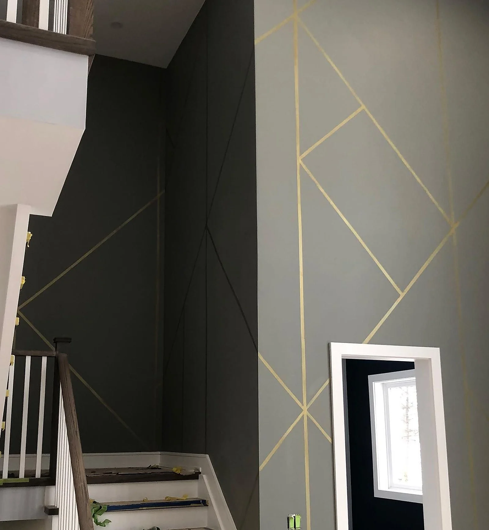 Dark stairwell wall with geometric gold lines