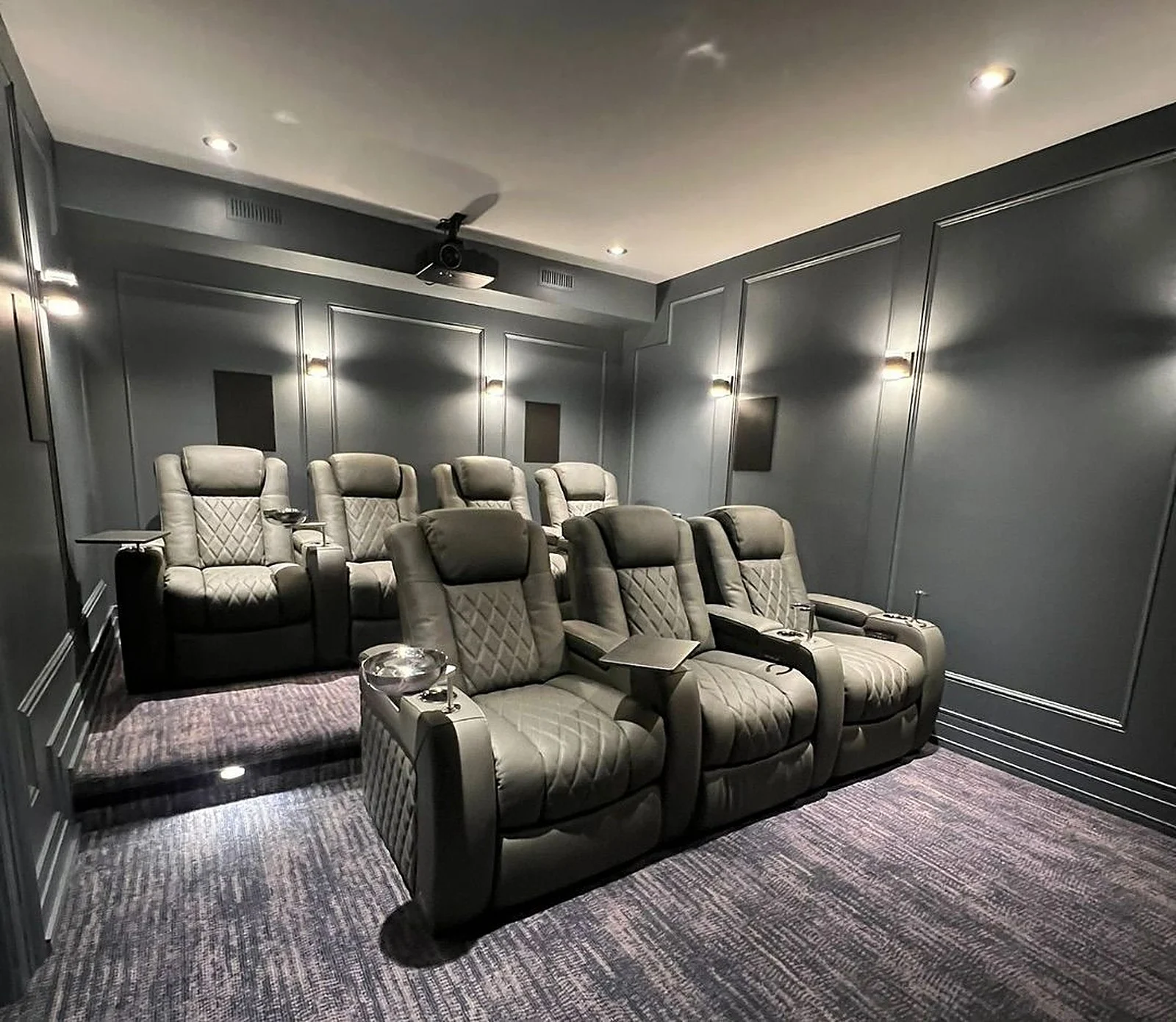 Home cinema with charcoal panelled walls