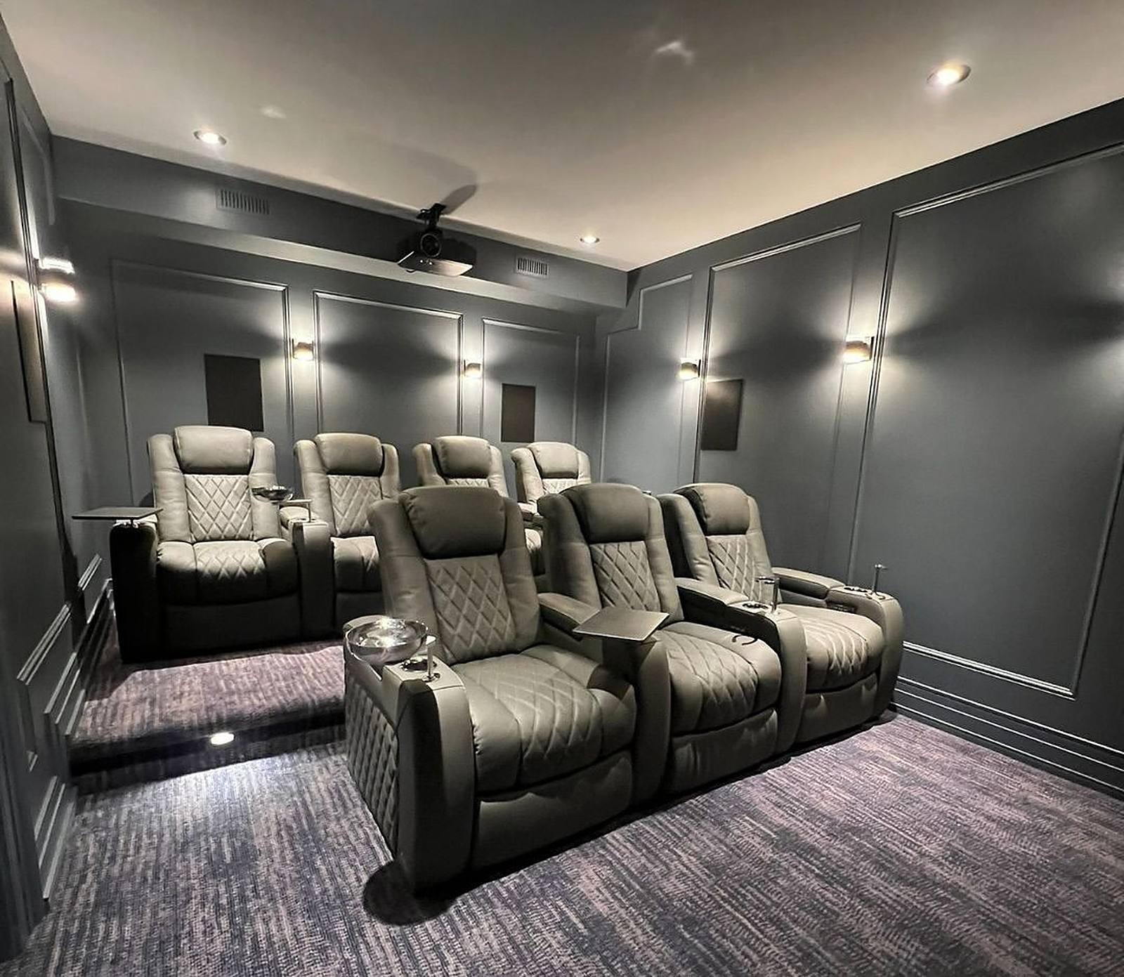 Home cinema with charcoal panelled walls