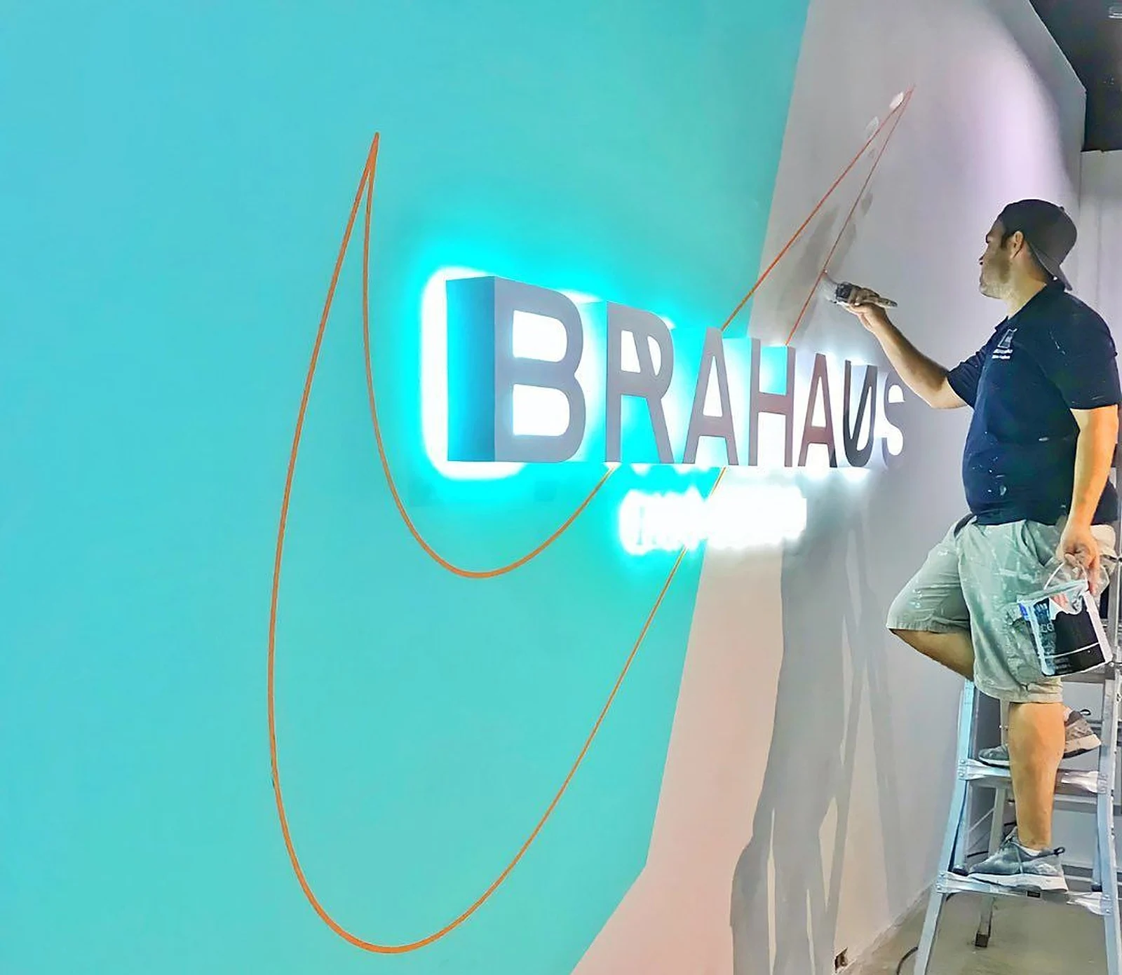 Painting a teal feature wall for a Nike space