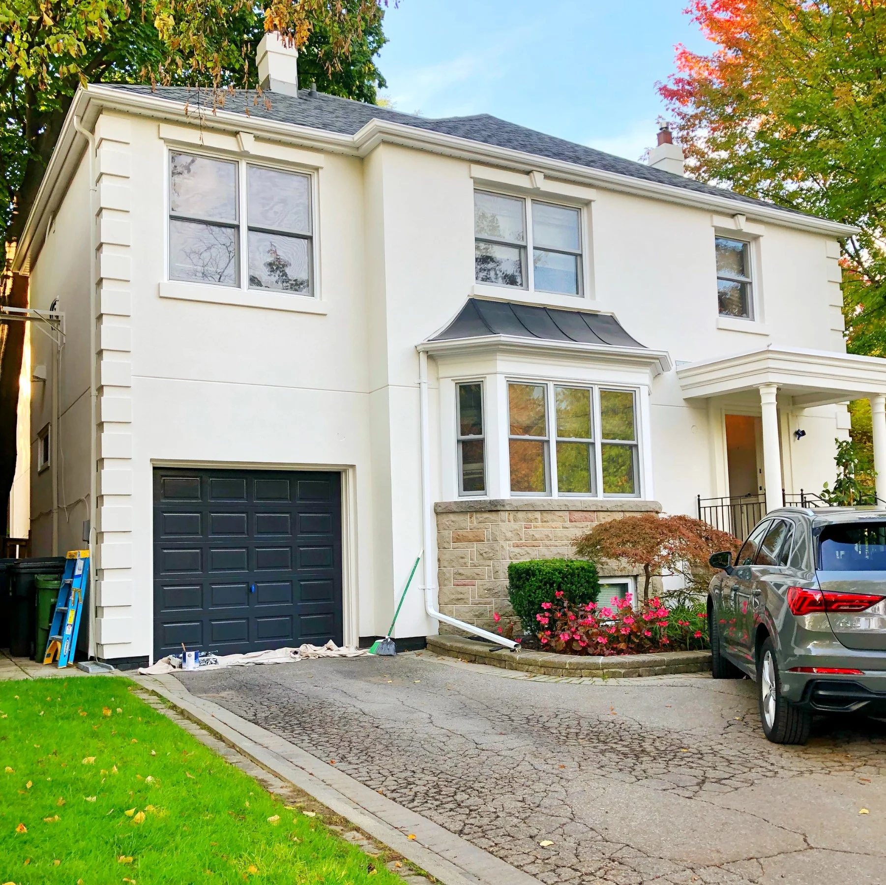White stucco house with black accents after exterior painting